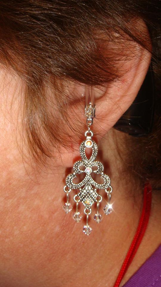 Kathy adorns her cochlear implant with the first decorative charm ever made for a CI by Hayleigh's Cherished Charms. 