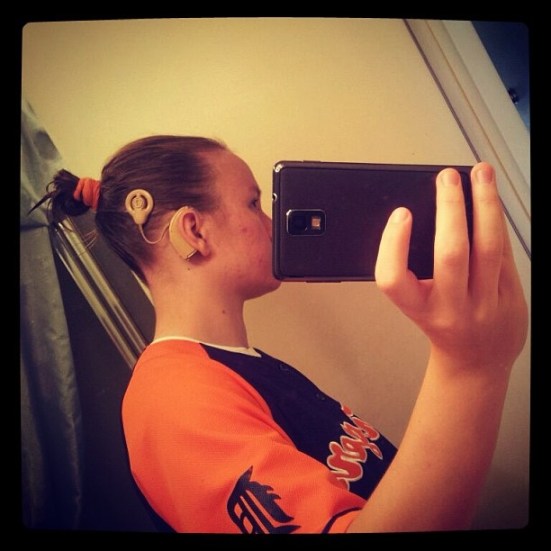 What's more fun than posing for Show Me Your Ears? Snapping your own profile in the mirror! Rikki has worn a cochlear implant for 16 years. Now that's what I call a Kodak moment. ;)